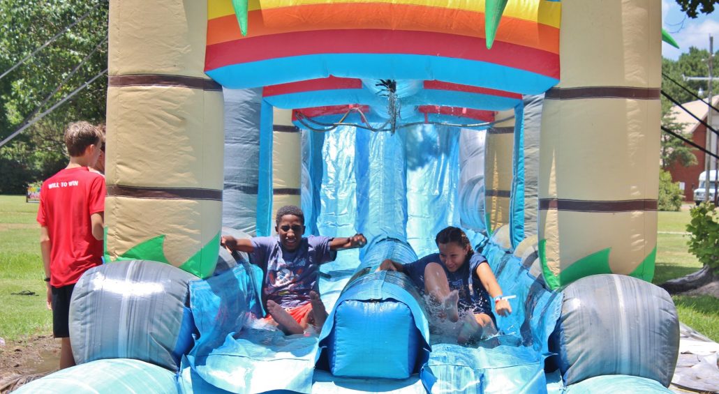 Kids racing down the giant waterslide