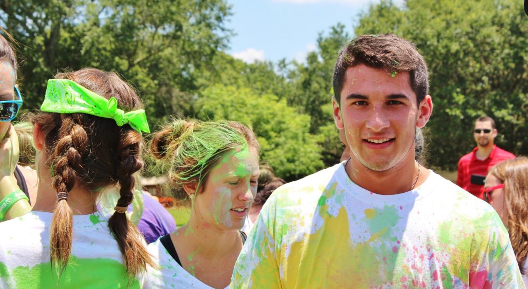 Campers covered in color celebrating at Camp Fuego